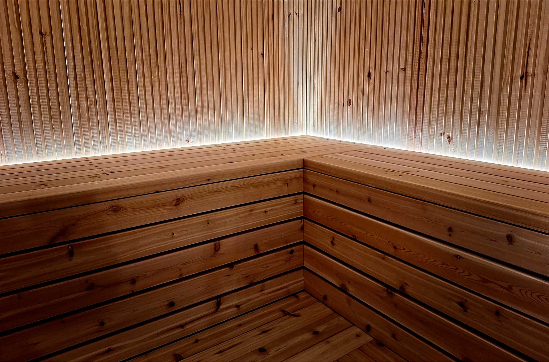 Custom-Sauna-Bench Custom bespoke sauna designed for client needs featuring natural wood and lighting